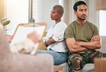 military husband and wife sitting back to back angrily