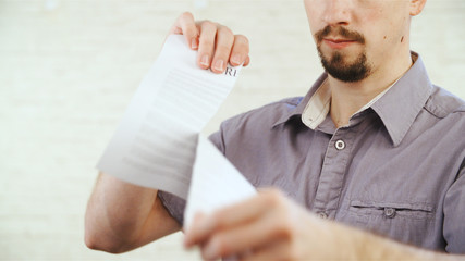 man ripping up divorce agreement