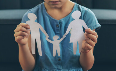 child with paper family cutout